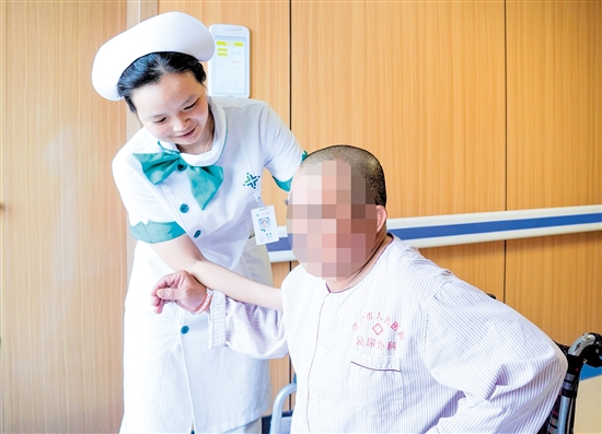 護(hù)士攙扶雙下肢無力患者上病床。