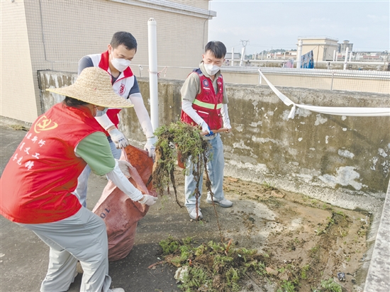 廣大黨員干部當(dāng)先鋒，圖為鶴山市桃源鎮(zhèn)黨員干部正在清理天臺(tái)垃圾。