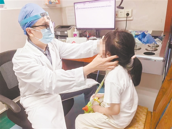 金鵬為患兒進(jìn)行檢查。