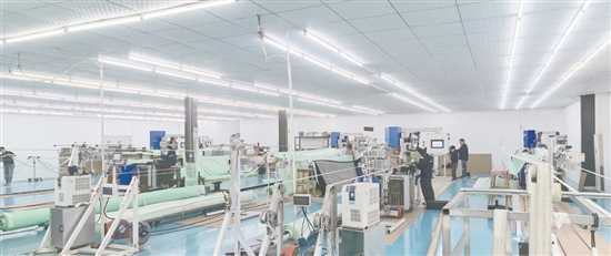 江門鴻榮紡織研究院有限公司的生產(chǎn)車間內(nèi)，一臺臺先進設備全速運轉，工作人員正有條不紊地操作設備。