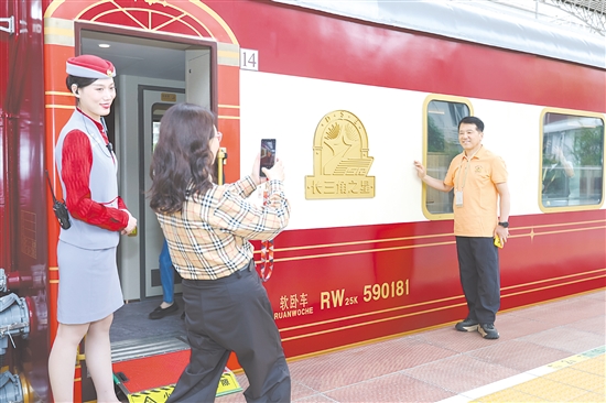 5月19日，長三角地區(qū)首趟舒適型旅游列車“長三角之星”從鐵路上海西站始發(fā)，旅客在登車前拍照留念。新華社發(fā)