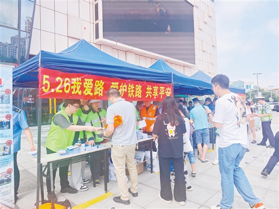 活動現(xiàn)場，工作人員向群眾宣傳愛路護(hù)路知識。